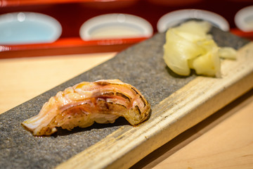 sushi raw fish on rice served on a plate