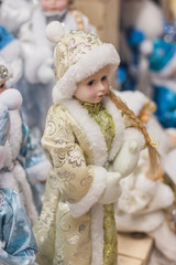 Christmas girl dolls, snow maiden for presesents or decoration, carry gifts sale, market, realization in the shop