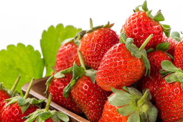 A bowl of beautiful strawberries isolated on white background with clipping path, close up, macro.