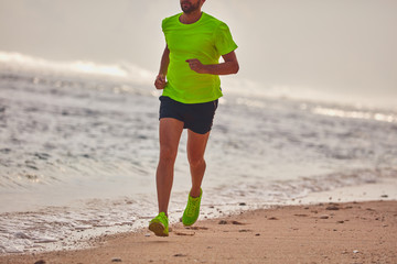 Man running / jogging on a tropical exotic beach.