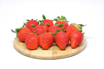 red strawberry on wooden plate