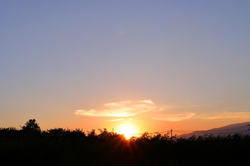 Fototapeta premium orange sun light on beautiful sunset clear blue sky background