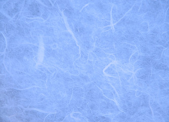 Obraz premium Blue handmade mulberry paper texture background.Natural rough rice craft sheet textured pattern close up.Selective focus.