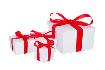 Obraz premium Stack of presents white gifts ribbon red bow isolated on white background