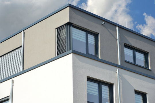 Glasfenster über Eck mit Rolladen an modernem Wohngebäude