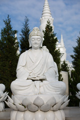 The white statue of Buddha was illuminated by the sun