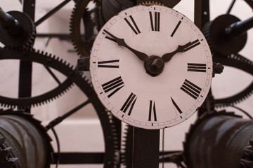 Detail picture of dial and cogwheels of grandfather clock