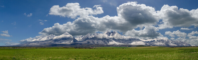 Extra wide panorama of High Tatra mountains during April with snowy hills Vysoke Tatry Slovakia
