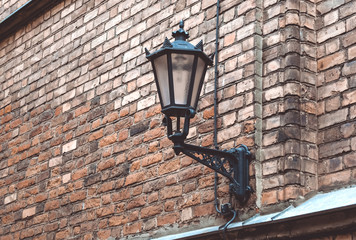 Wall lantern hanging on a roof of old house in the center of Riga, Latvia. October 25, 2018.