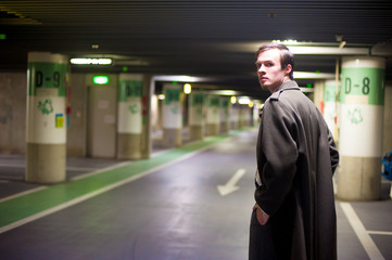 Caucasian male model poses for pictures on the street