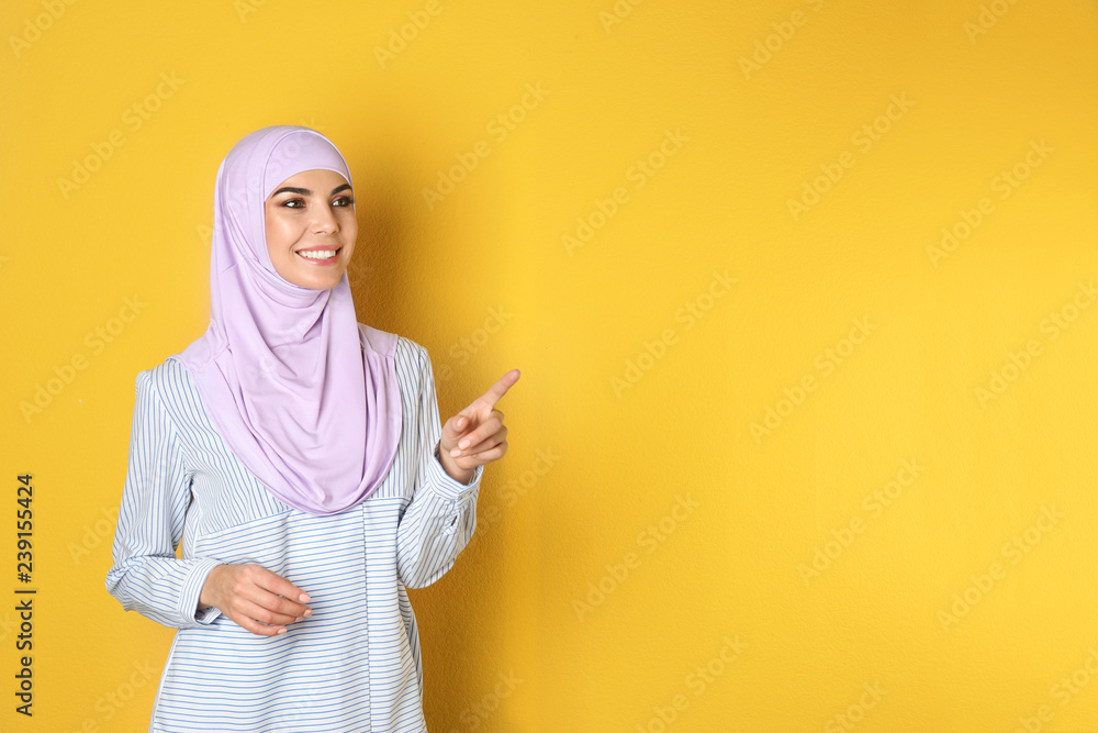 Canvas Prints portrait of young muslim woman in hijab against color background. space for text