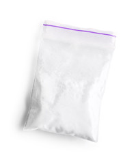 Cocaine in plastic bag on white background, top view