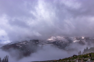 tall mount of mountain top hidden by clouds and mist