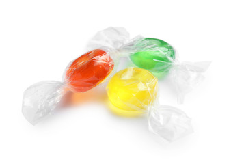 Different delicious colorful candies on white background