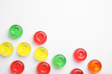 Delicious colorful candies on white background, top view