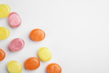 Delicious colorful candies on white background, top view