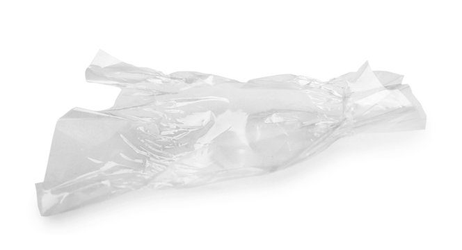 Crumpled transparent candy wrapper on white background