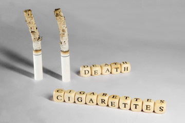 A terrible picture about death due to smoking. Smoking cigarettes on a dirty gray background