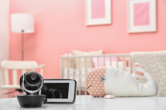 Baby monitors on table in room, space for text. CCTV equipment