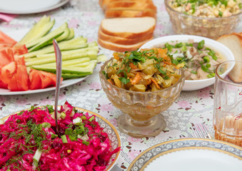 Salads and side dishes in plates on the table
