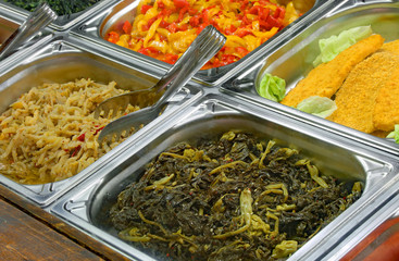 self service canteen with breaded meat cutlet and cooked spinach