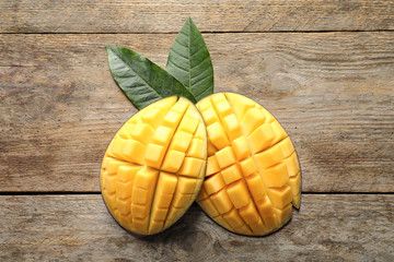 Flat lay composition with mango on wooden background