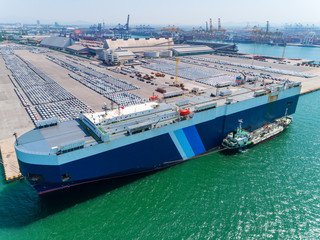 Aerial view of large RORO Vehicle carrier vessel parking for loading car at sea port.