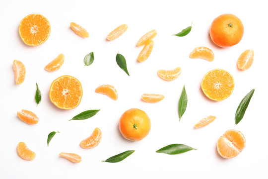 Composition with tangerines and leaves on white background, top view
