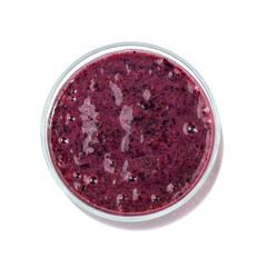Blueberry smoothie in a glass jar isolated on white background. Top view