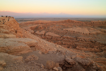 Many of people after watching beautiful sunset at the Moon Valley in Atacama desert, San Pedro Atacama, north of Chile