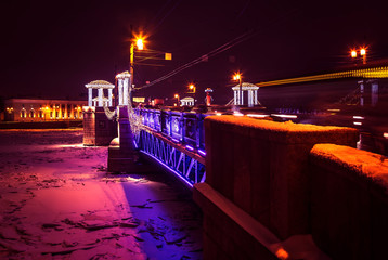Fototapeta na wymiar Night cityscape with river and bridge in Saint-Petersburg. Lantern lights on bridge.