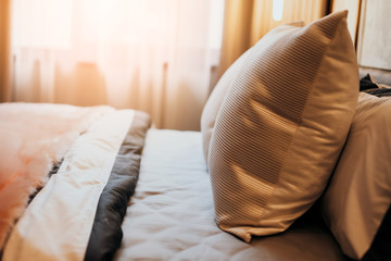 Bed maid-up with clean white pillows and bed sheets in beauty bedroom. Close-up. interior background