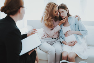 Mother with Pregnant Daughter in Doctor Office.