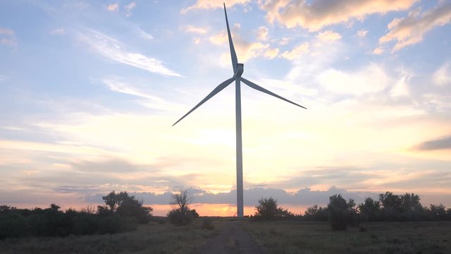 Wind power plant at sunset