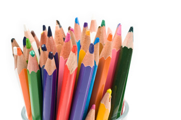 Bunch of colored pencils isolated on white background. Selective focus.