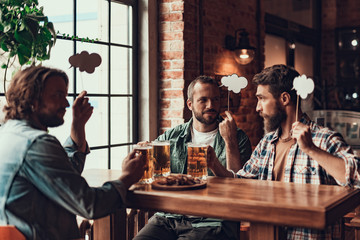 Friends with drinks and speech bubbles spending time at pub