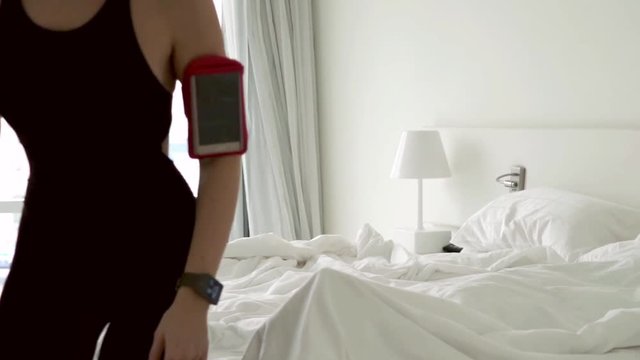 Young sporty woman going for run, while her boyfriend sleep

