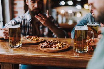 Friends enjoying drinks and snacks at pub