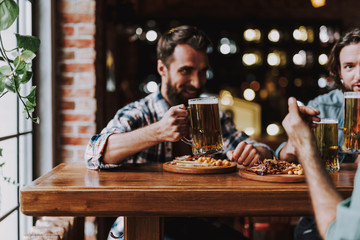 Young bearded man spending time with friends at pub
