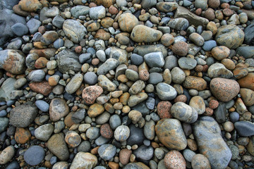 Colorful, smooth granite pebbles on beach in Acadia National Park, Maine.
