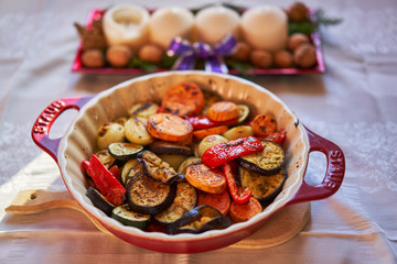 Close up picture of grilled spicy vegetables, onion, sweet potatoes, pepper, zucchini and aubergine or eggplant in baking bowl ready to served like light vegetarian dinner