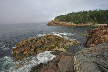 The rugged coast of Acadia National Park, Maine, bathed in early morning light in summer.