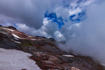 blue sky and fluffy white clouds over snowy mountain