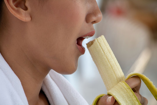 Woman eating banana, concept business.