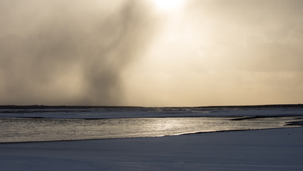Abstract landscape water and sky backlit at sunset iceland
