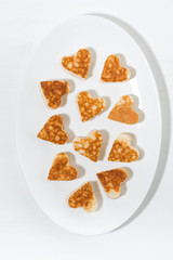 plate of pancakes in the shape of heart, vertical