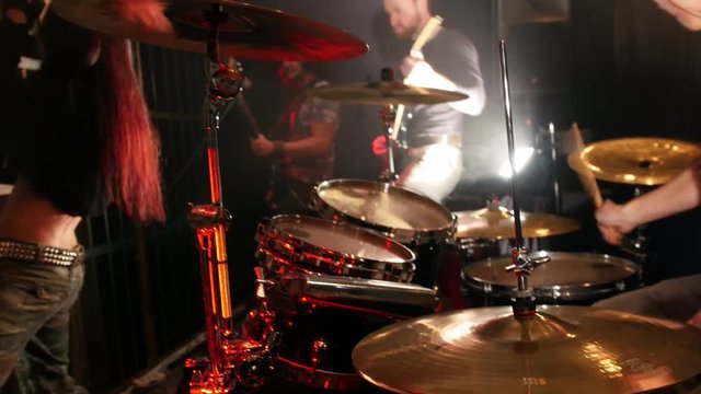 Young man playing drums in a rock band