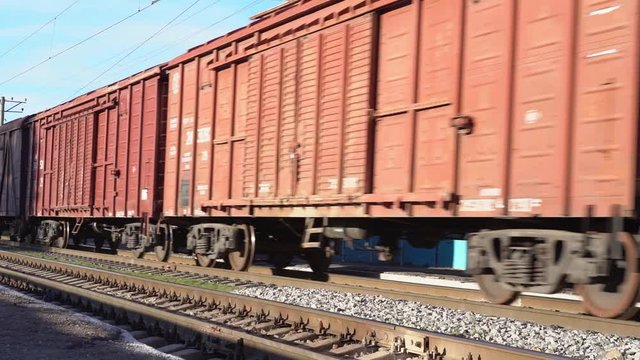A railway train of shipping containers, slow motion video