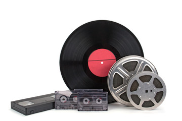 Old film reel with strip , photographic film, audio recordings and vinyl records .