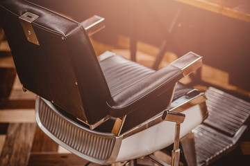 Workplace of hairdresser. Stylish vintage barber chair in interior close up